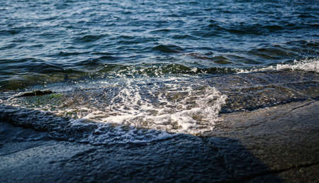 Waves at the seashore. Selective focus with shallow depth of field.の写真素材
