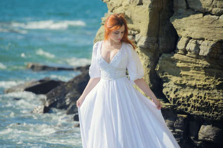 Young woman over blue sea background.の写真素材