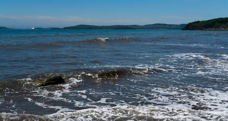 Waves at the seashore. Selective focus with shallow depth of field.の写真素材