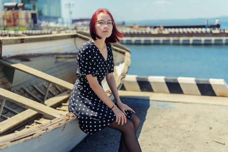 Young woman sitting down on the boat.の写真素材