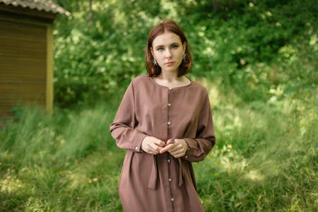 Outdoors portrait of beautiful young woman in the park. Selective focus.の写真素材