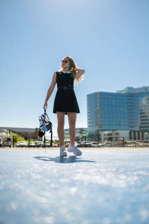 Woman in dress enjoys sun in summertime.の写真素材