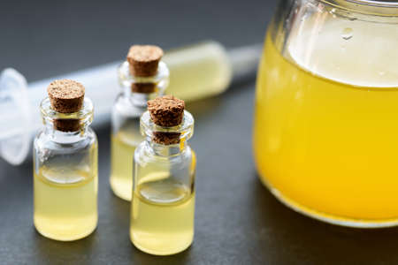 Orange colored liquid in a bottle. Concept.