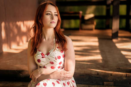 Outdoors portrait of beautiful young woman in the park. Selective focus.の写真素材