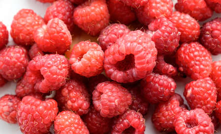 Heap of raspberries on the white background.の写真素材