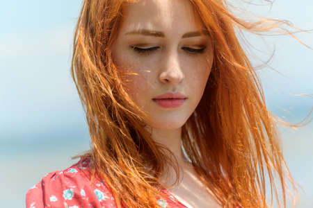 Portrait of pensive redhead young woman.の写真素材