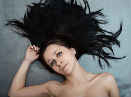 Beautiful black hair. Top view of women with beautiful hair on dark background.の写真素材