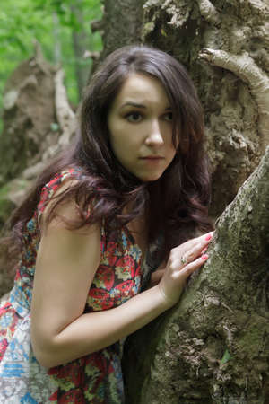 Scared young woman a forest at night.の写真素材