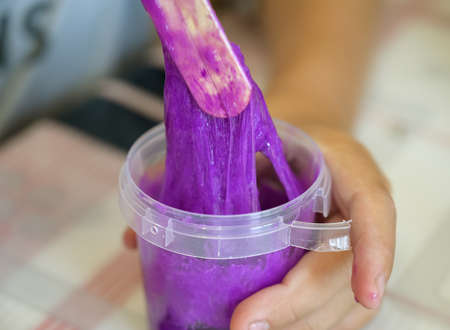Little girl makes a homemade slime. Selective focus.の写真素材
