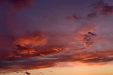 Dramatic sunset sky with orange colored clouds.の写真素材