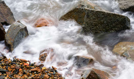 Waves at the seashore or pier aptured with a slow shutter speed. Natural abstract motion background.の写真素材