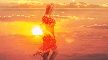 Double exposure of young woman and sunset sky.
