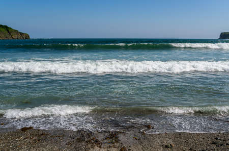 Waves at the seashore. Selective focus with shallow depth of field.