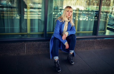 Street portrait of young woman wearing blue coat.の写真素材