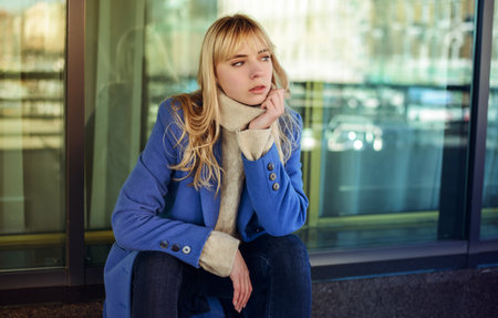 Street portrait of young woman wearing blue coat.の写真素材