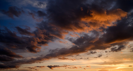 Sunset sky with orange clouds. Nature background.の写真素材