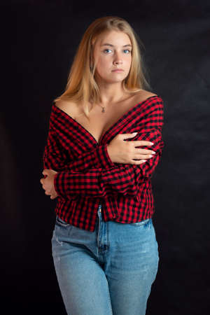 Portrait of beautiful woman with blue eyes in black-red shirt.の写真素材