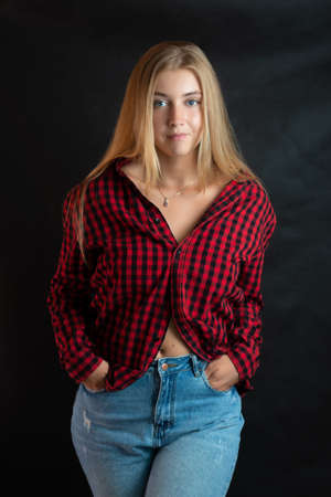 Portrait of beautiful woman with blue eyes in black-red shirt.の写真素材