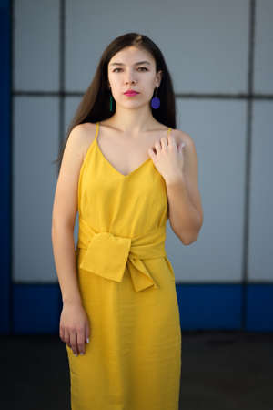 Autumn portrait of beautiful woman in yellow dress and pink blazer.の写真素材