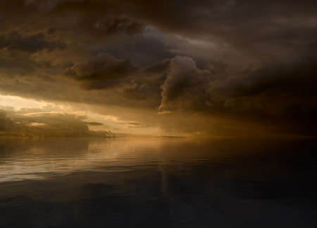 Sunset sky with clouds and sunlight reflect in water surface.の写真素材