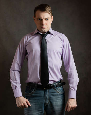 Portrait of angry young man on dark background.の写真素材