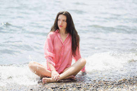 Beautiful adult woman enjoy the sea on a sunny day.の写真素材