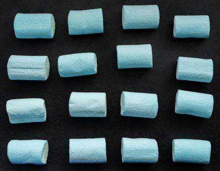 Blue marshmallows on dark background.の写真素材