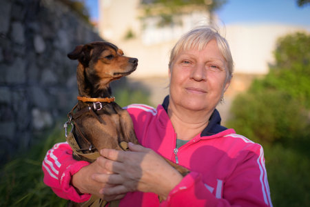 Aged woman with her dog. outdoor portrait.の写真素材