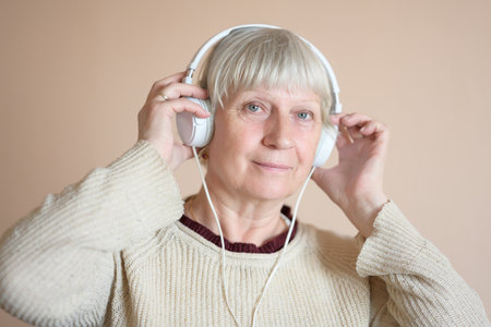 Beautiful middle aged woman with headphones at home.