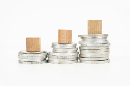 Stack of Coins with Wooden Blocksの写真素材