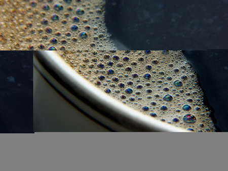 Bubbles in a cup of coffee, macro shot, abstract background