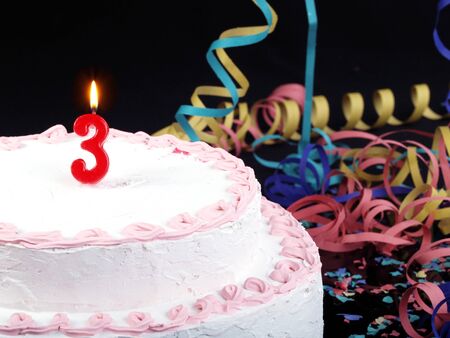 Birthday cake with red candles showing No. 3の写真素材