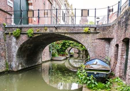 the quiet channel with an old boat on the bank, utrecht, netherlandsの写真素材