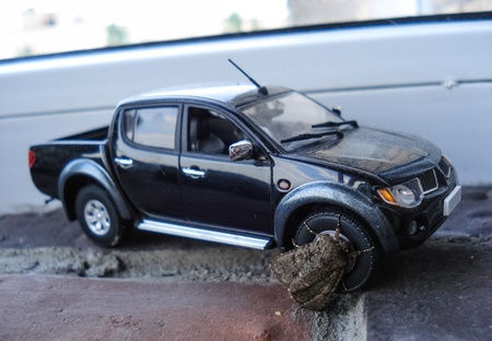 the moth is sitting on the wheel of the toy carの写真素材