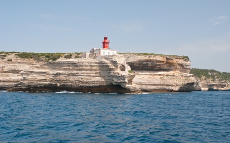 the lighthouse of Bonifacio located on the rocky shore of Corsica islandの写真素材
