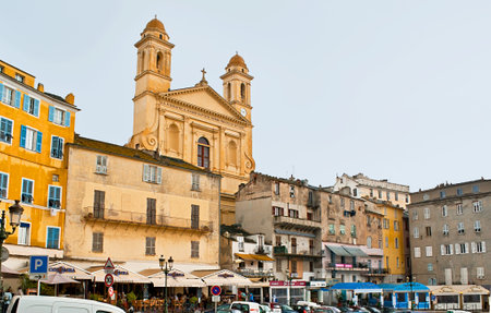 BASTIA, FRANCE - MAY 1, 2013: The Quay of 1er Bataillon de Choc with street cafes and tourist shops and towers of St Jean Baptiste church , on May 1 in Bastia.のeditorial素材