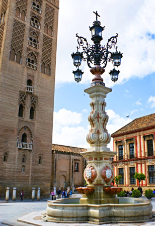 SEVILLE, SPAIN - MAY 3, 2013: The fountain decorated with an old lamppost was created for Latin American Exhibition, located near Giralda tower, on May 3 in Seville.のeditorial素材