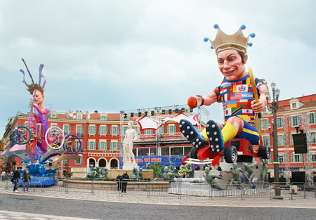 NICE, FRANCE - FEBRUARY 21, 2012: The theme of Carnival was The King of Sport, so the large figures of the King and Queen of Sport were located on the Place Massena in awaiting of the events, on February 21 in Nice.のeditorial素材