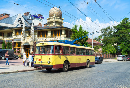 CHERNIVTSI, UKRAINE - JUNE 20, 2014: The trolley on the station next to the unusual building of the Restaurant Sorbonne in the city centre, on June 20, 2014.のeditorial素材