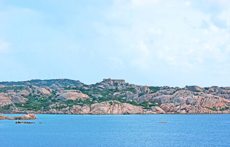 LA MADDALENA, SARDINIA - SEPTEMBER 25, 2012: The rocky Island of Santo Stefano with the medieval Castello Napoleonico on the top, on September 25 in La Maddalena.の写真素材