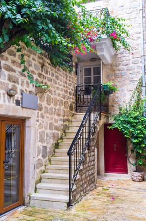 BUDVA, MONTENEGRO - JULY 12, 2014: The tiny staircase leads to the old house, decorated with green plants, on July 12 in Budva.のeditorial素材