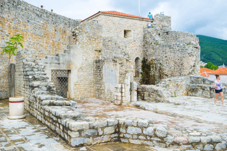 BUDVA, MONTENEGRO - JULY 12, 2014: The Venetian Citadel located in the picturesque place, it walls surrounded by Adriatic Sea, on July 12 in Budva.のeditorial素材