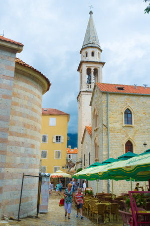 BUDVA, MONTENEGRO - JULY 12, 2014: The best cafes and restaurants in Budva located next to the bell tower of St Ivan Cathedral, on July 12 in Budva.のeditorial素材