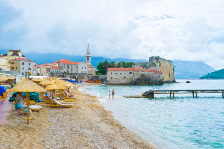 BUDVA, MONTENEGRO - JULY 12, 2014: The Morgen Beach considered the best in town, because it boasts the comfortable conditions of rest and perfect view on the Venetian citadel, on July 12 in Budva.のeditorial素材