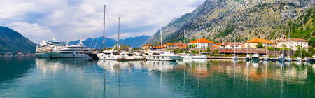 Panorama of Kotor port with the fishing boats, large yachts and cruise liner, Montenegro.の写真素材