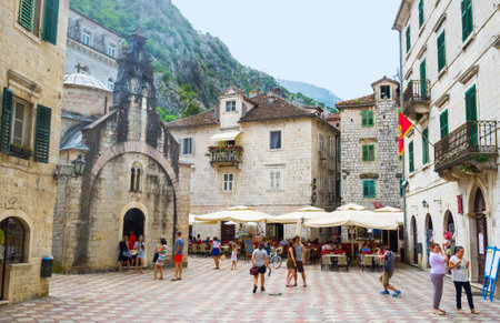 KOTOR, MONTENEGRO - JULY 12, 2014: The tiny St Lukas chapel located on the busy square with many shops and street cafes, on July 12 in Kotor.のeditorial素材