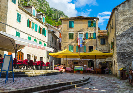 KOTOR, MONTENEGRO - JULY 12, 2014: The tiny square is the shelter for many street cafes with local cuisine, wine and beer, on July 12 in Kotor.のeditorial素材