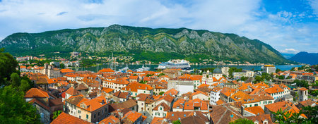 KOTOR, MONTENEGRO - JULY 15, 2014: Panorama of the Kotor bay and the roofs of the old town with the great mountains , on July 15 in Kotor.のeditorial素材