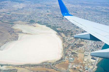 The aircraft decreases altitude over the salt lake of Larnaca to make a landing in Larnaca International Airport, Cyprus.の写真素材