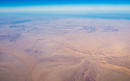 The flight over the North Africa - the desert and the Nile river on the background.の写真素材
